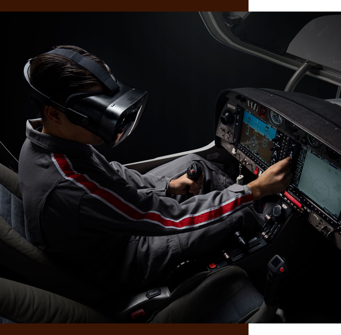 Man wearing VR headset sitting in airplane cockpit