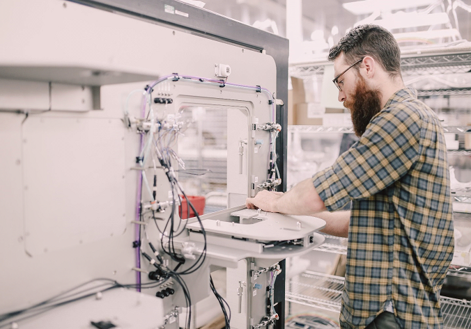 Applied Engineering technician assembling a precision electromechanical system