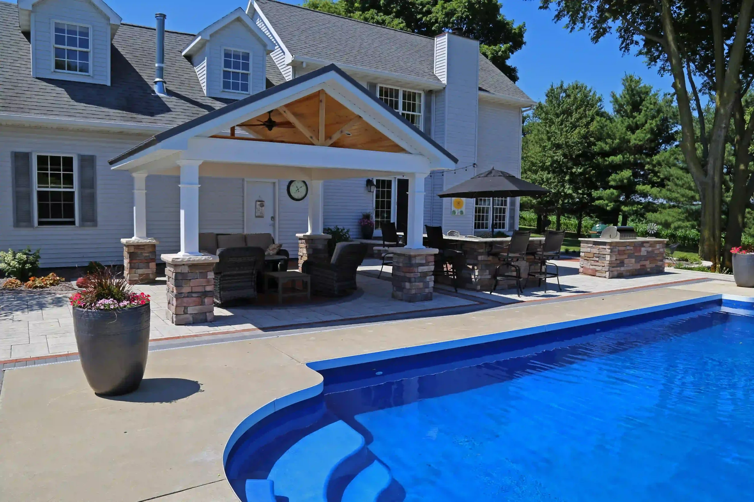 Custom pool, pergola, and outdoor kitchen patio at Freeman Residence by Green View in Central Illinois