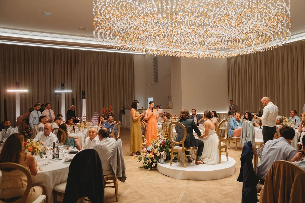 Emma and Joseph wedding speeches and guests in the reception hall at Château de Laurentie