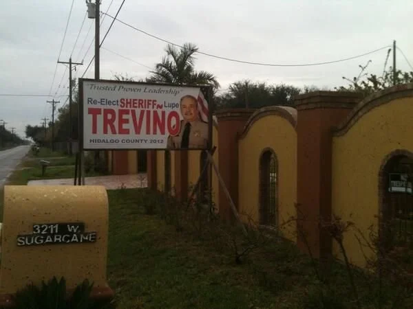 A “Re-elect Sheriff Trevino” sign beside The Rooster’s house