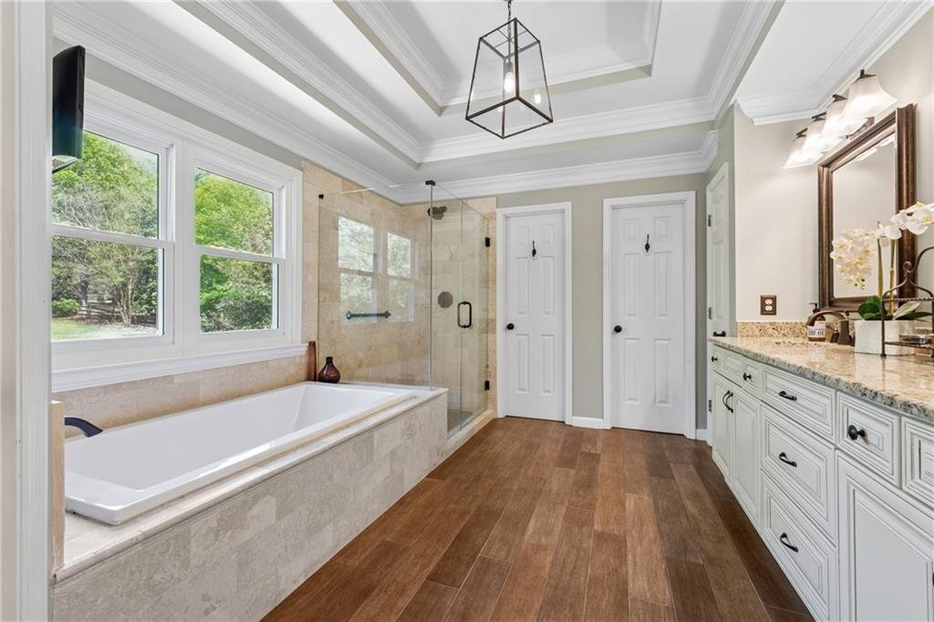 Luxurious bathroom with double vanity and soaking tub in 590 Kensington Farms Drive