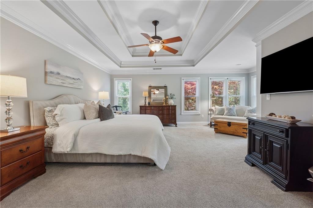 Modern bedroom in 590 Kensington Farms Drive with plush carpet and natural light