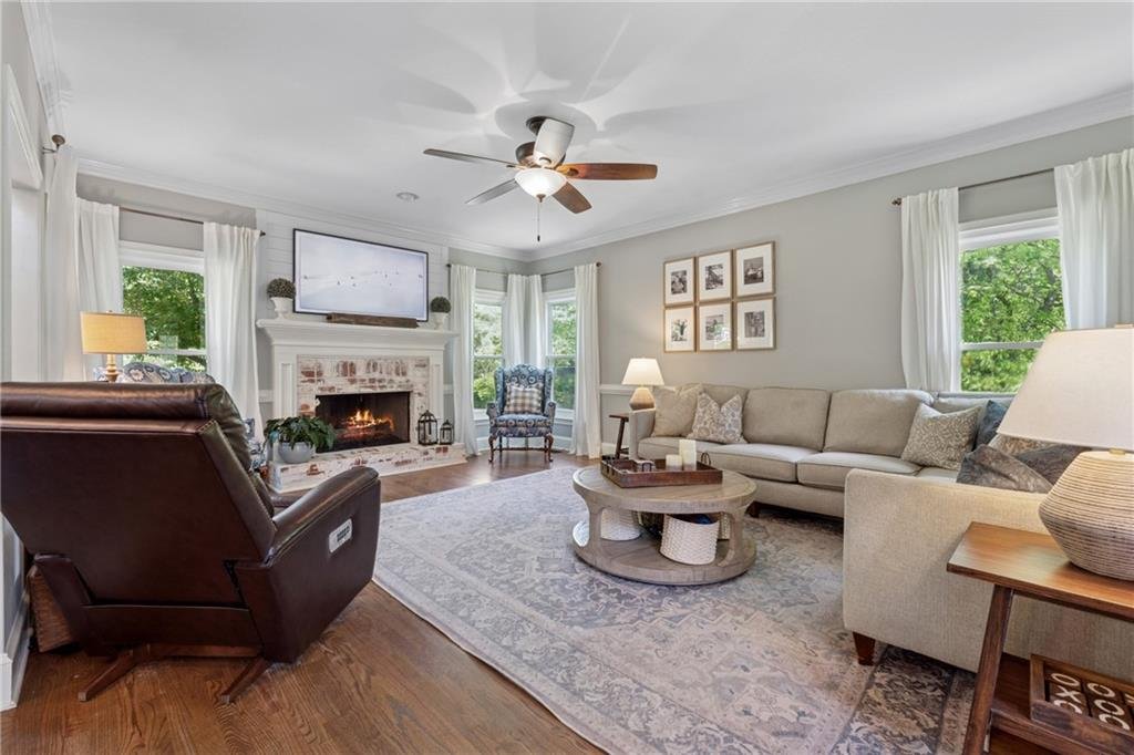 Elegant hallway with neutral tones and hardwood floors inside 590 Kensington Farms Drive