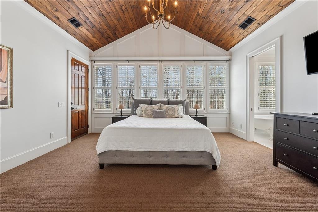 13360 Freemanville Road bedroom β spacious master suite with large windows and seating area