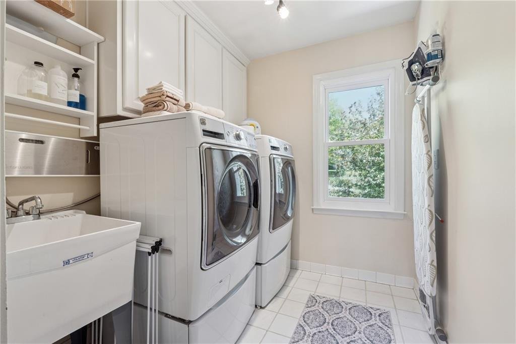 Bright and functional laundry room with cabinets at 590 Kensington Farms Drive