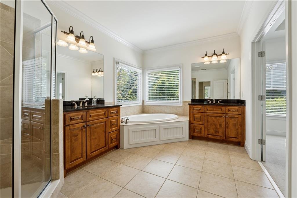 12469 Danesfeld Drive bathroom – luxurious bath with modern fixtures and tile