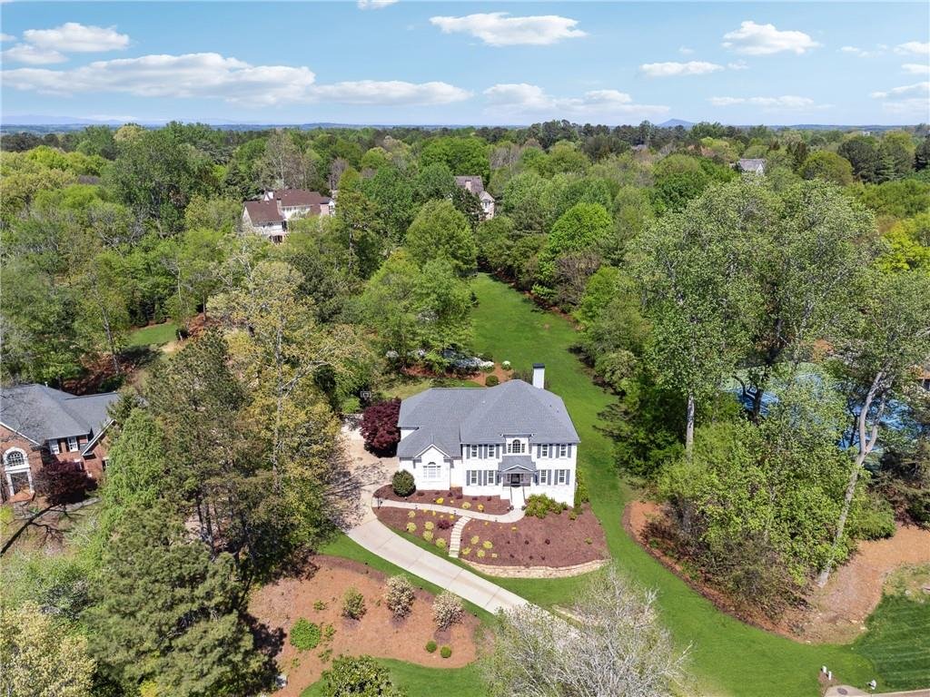 Aerial view of 590 Kensington Farms Drive property with large lot and landscaping