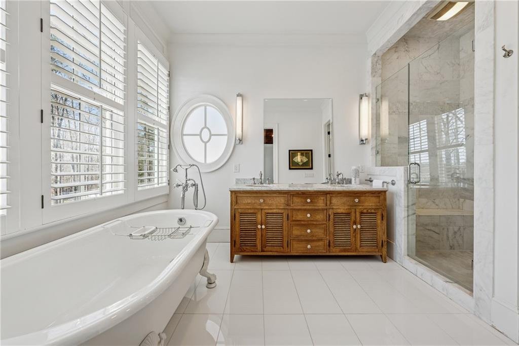 13360 Freemanville Road bathroom β luxury bath with soaking tub, dual sinks, and glass shower