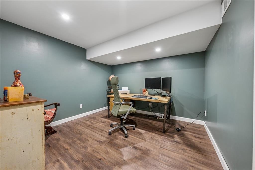 13360 Freemanville Road work room β home office with desk, shelving, and large windows