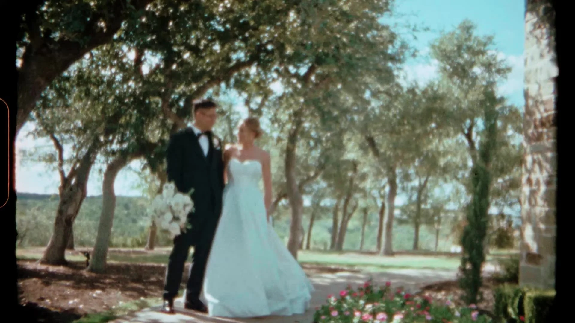 Jason and Rachel standing together under oaks at Canyonwood Ridge in Dripping Springs, Texas, Super 8 frame
