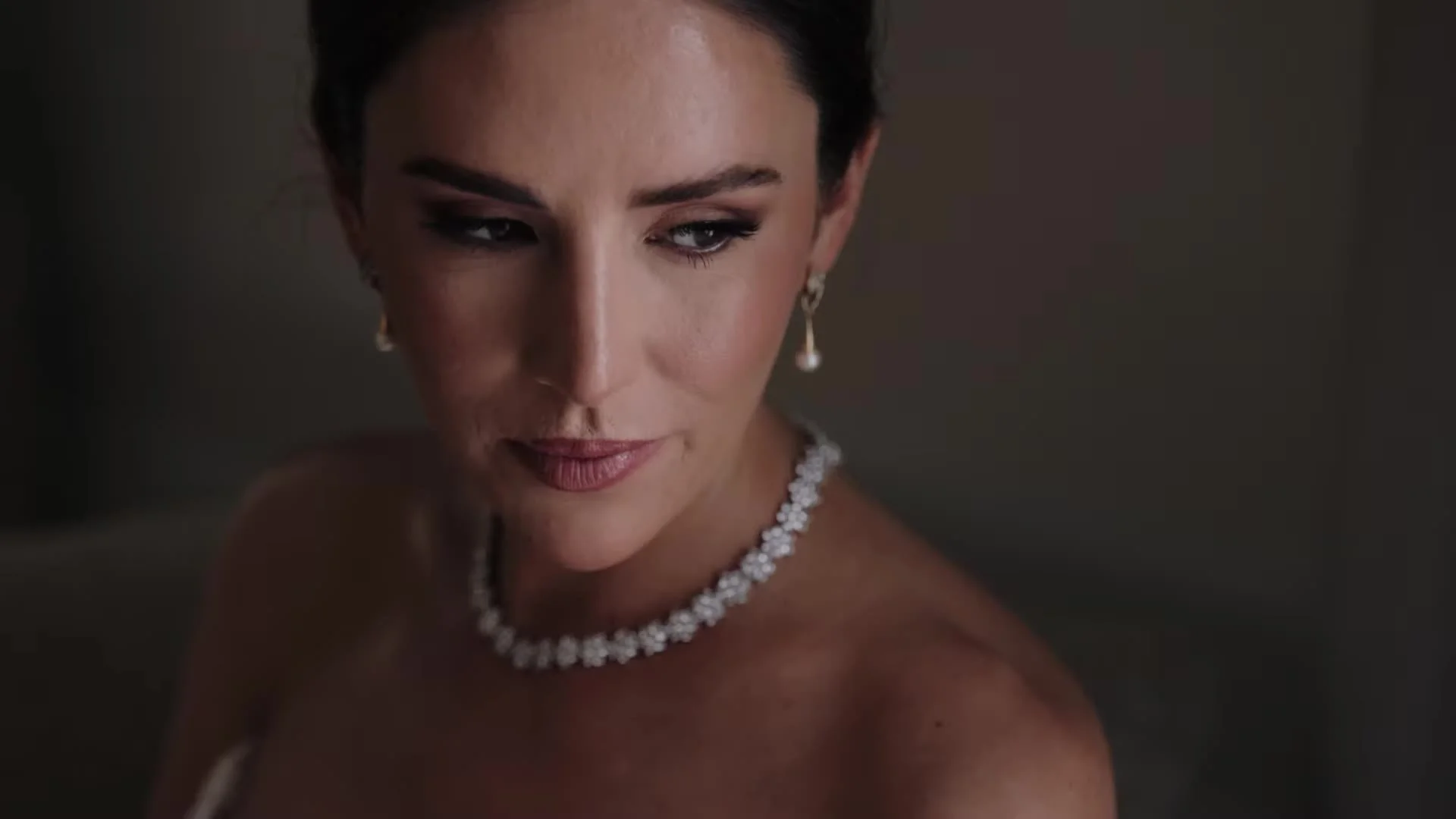 Close up of Anna with diamond necklace and pearl drop earrings before her Driskill wedding in Austin, Texas