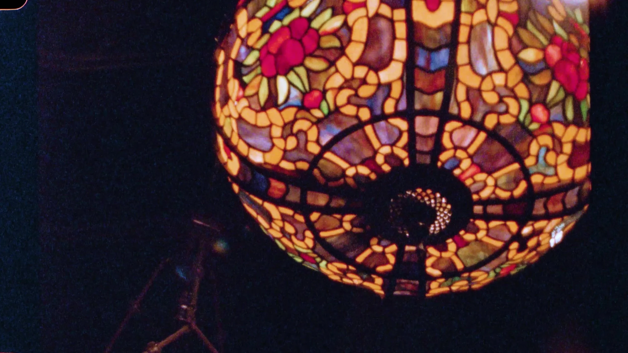 Close up of a lit Tiffany floral stained glass lamp at Nouveau Antique Art Venue in Houston, Texas