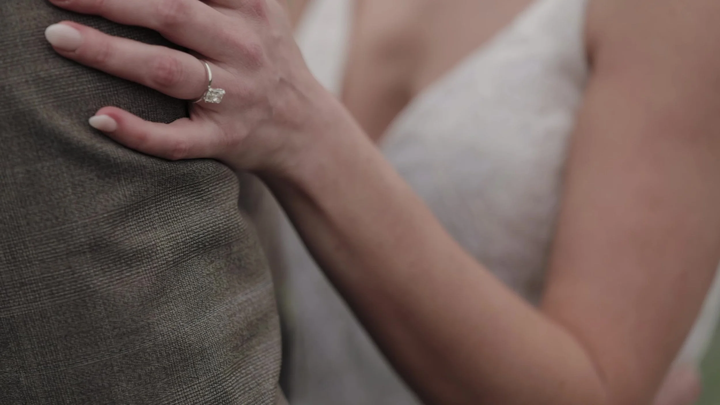 Close up of Heather's wedding ring on Chris's shoulder at Lady Bird Johnson Wildflower Center in Austin, Texas
