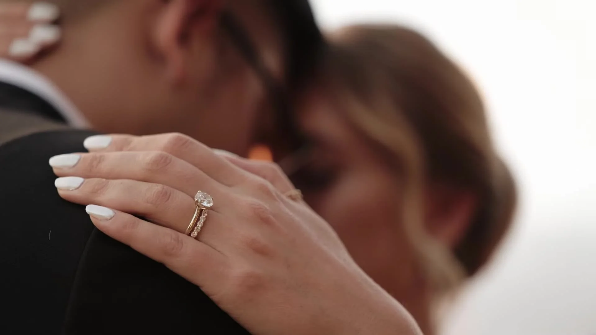 Close up of Rachel's diamond rings on Jason's shoulder at Canyonwood Ridge in Dripping Springs, Texas