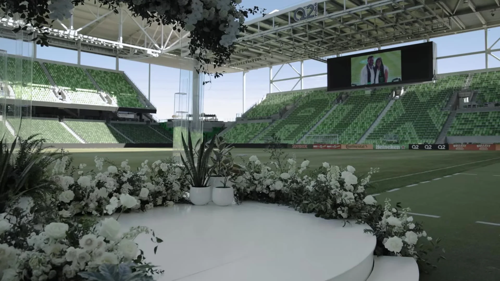 White floral ceremony circle on the soccer pitch at Q2 Stadium in Austin, Texas