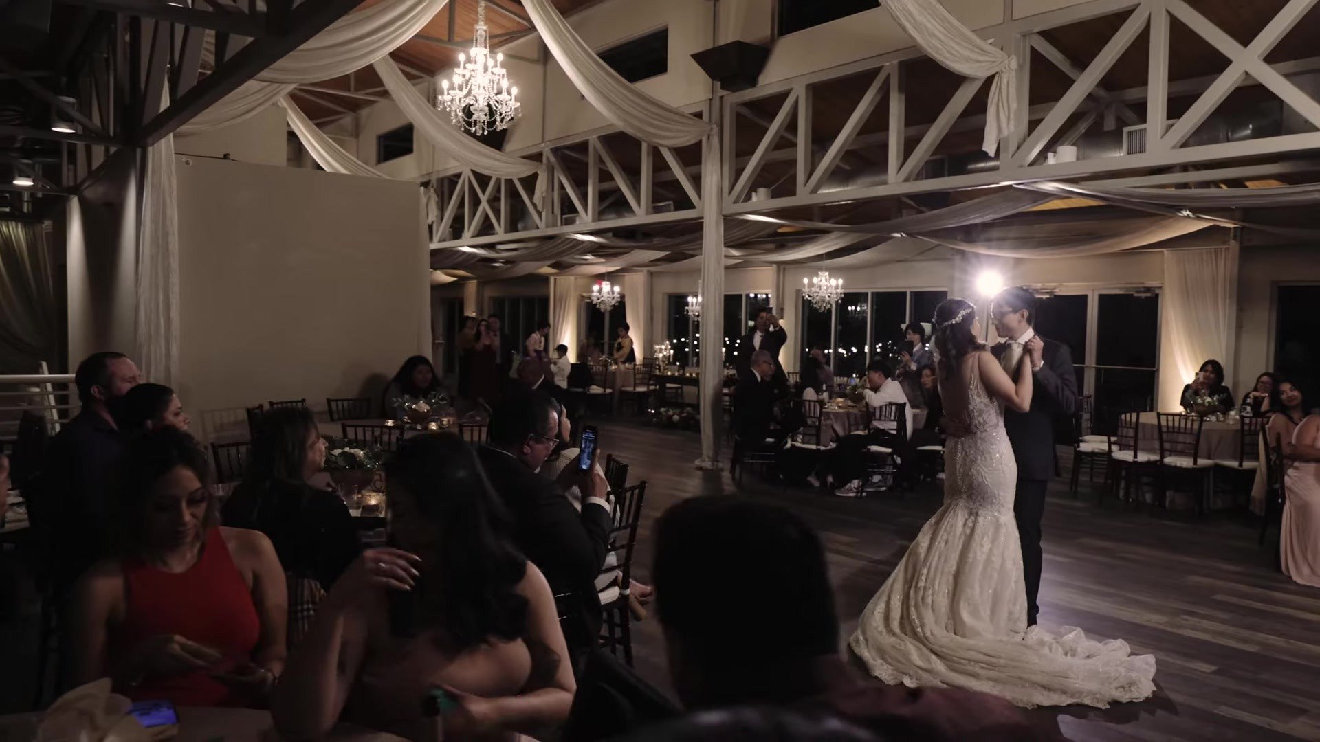 Manny and Jasmine first dance under draped ceiling and chandeliers at The Terrace Club Austin