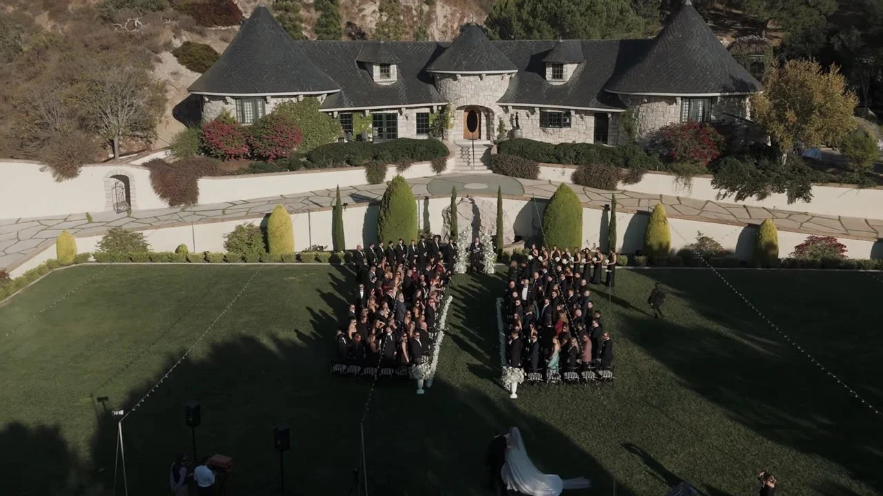 Aerial of the bride's long train as she starts down the aisle