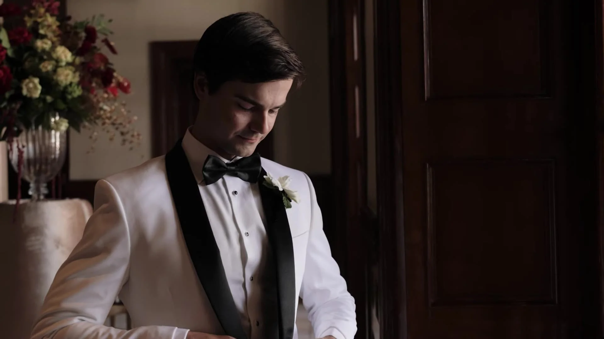 Grant in a white tuxedo jacket with black lapels and black bow tie getting ready in Austin, Texas