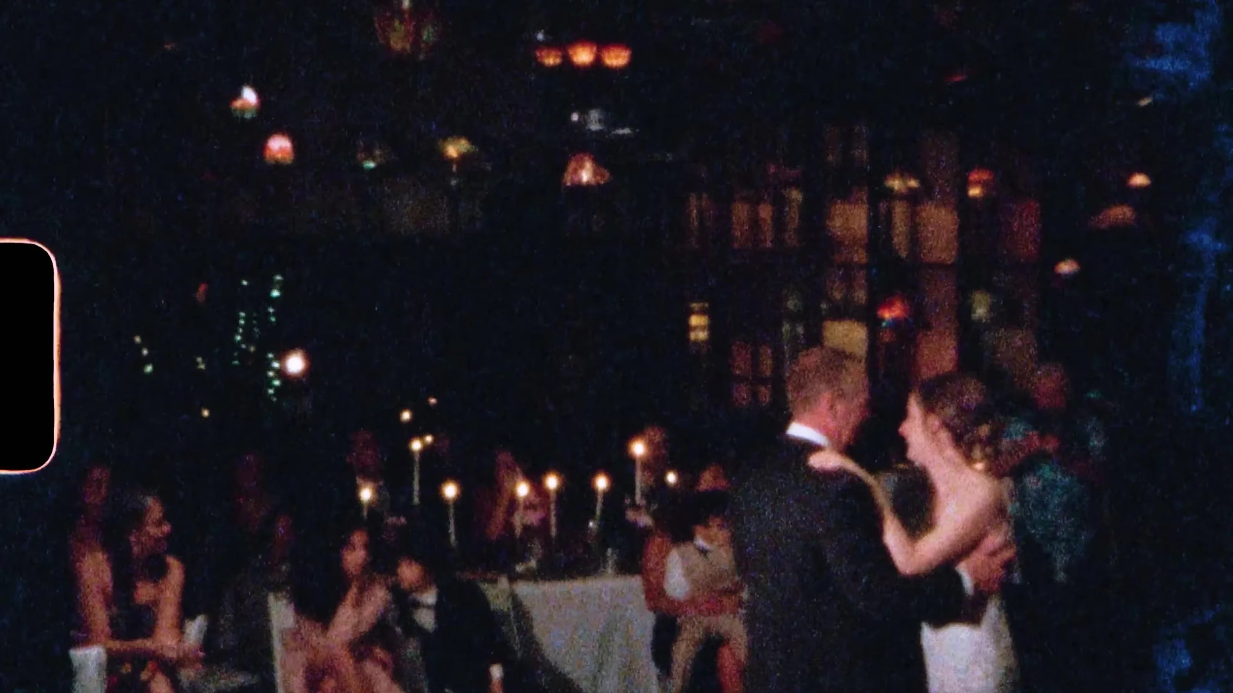 Film frame of the couple dancing under Tiffany lamps at Nouveau Antique Art Venue in Houston, sprocket edge visible
