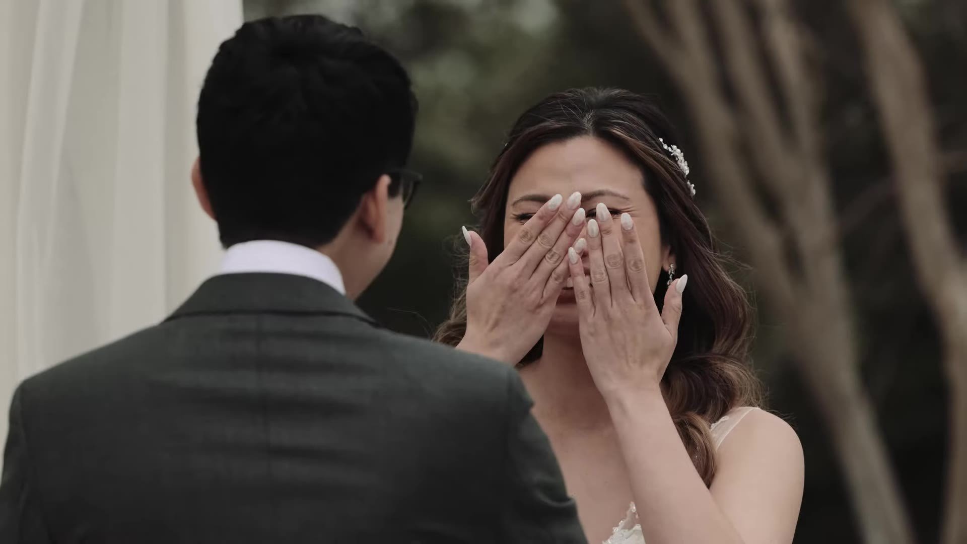 Jasmine covering her face with both hands laughing through tears during vows at The Terrace Club Austin
