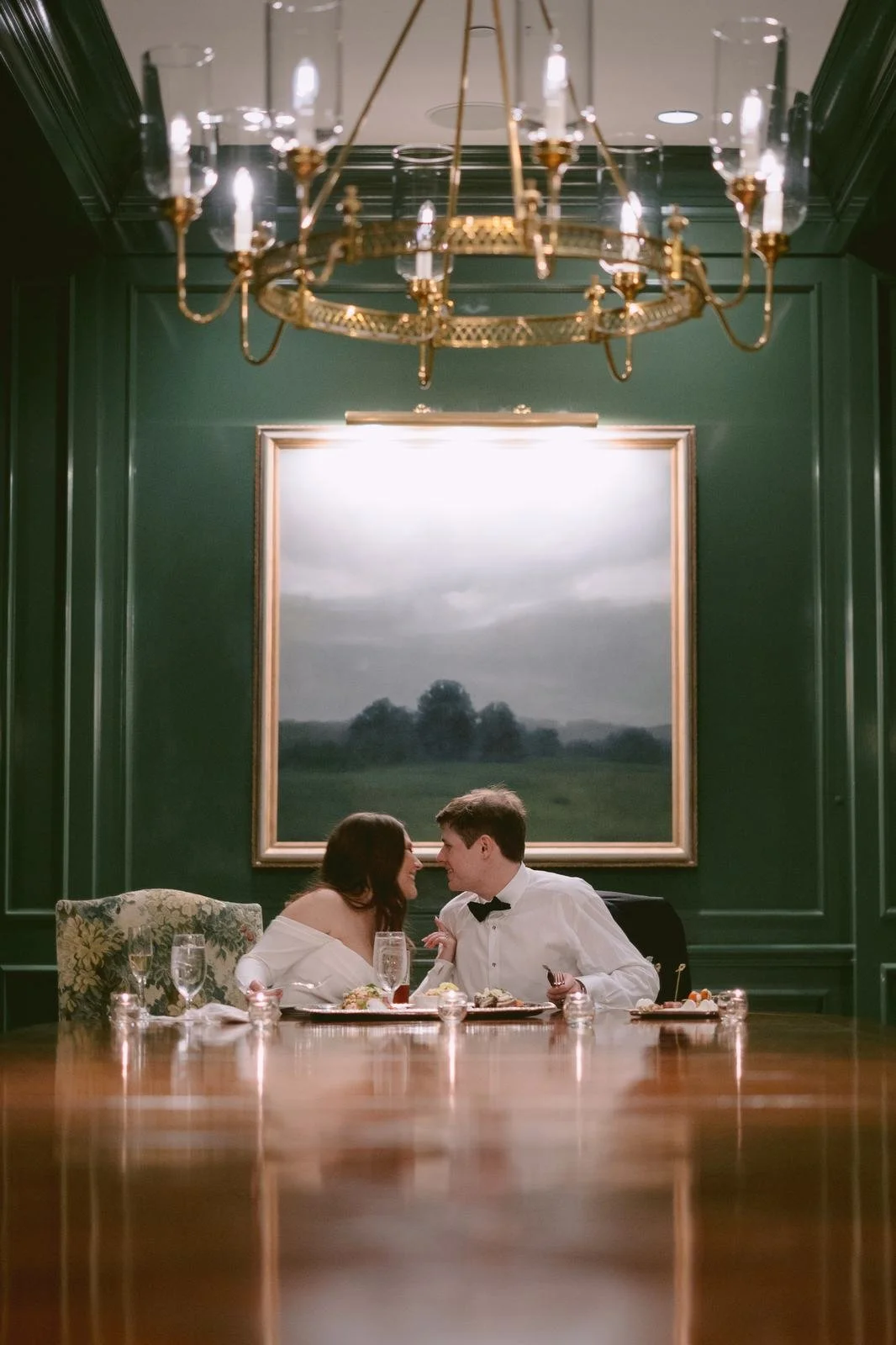 Bride and groom at candlelit emerald dining room wedding