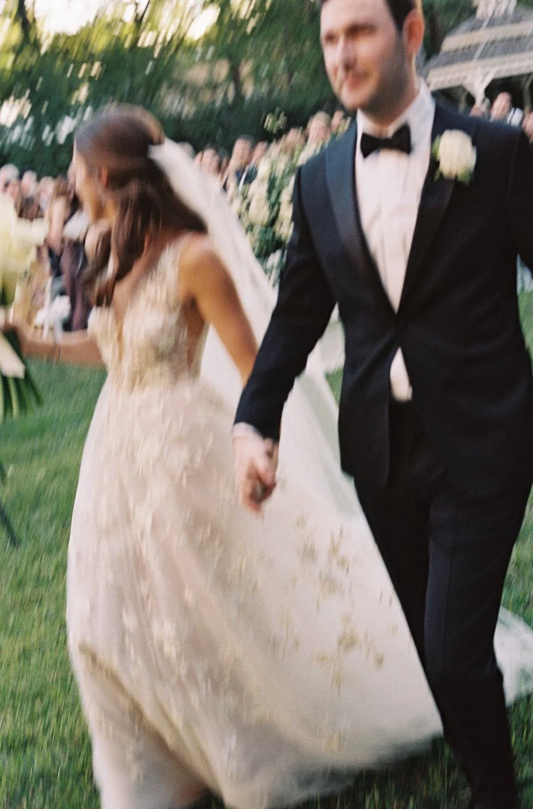 Motion blur photo of bride and groom walking hand in hand