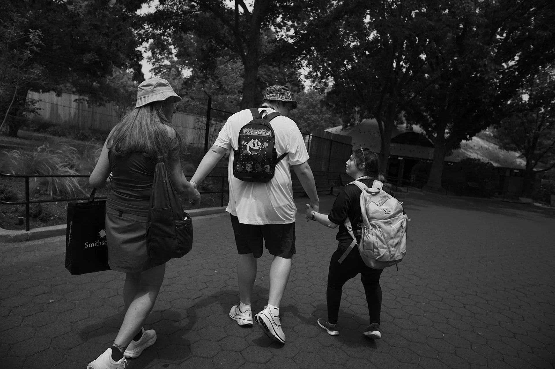 Christine, Luke, and Jadyne walk hand in hand.