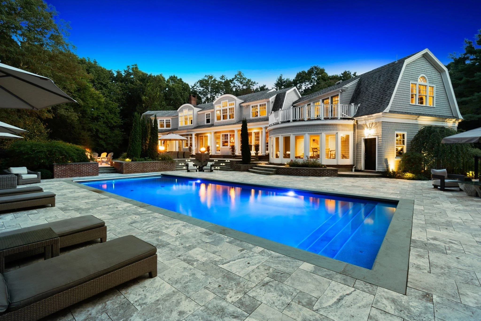 Shingle estate with resort pool at dusk