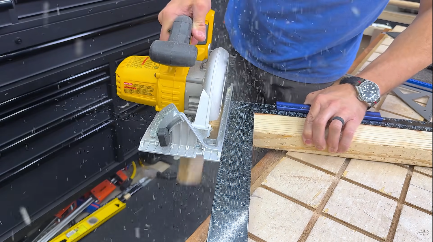 Framing square with stair tread guides locked at 22 1/2 degrees on the end of a 2x4 as a miter saw alternative