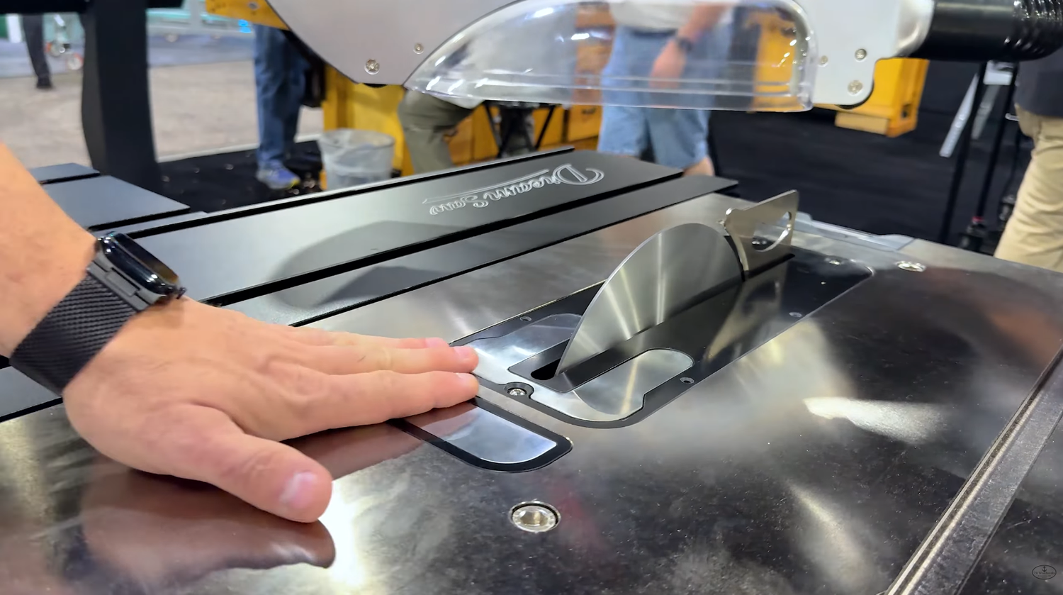 Hand approaching the blade on the Harvey D1 Dream Saw table saw as the blade drop safety system pulls the blade down