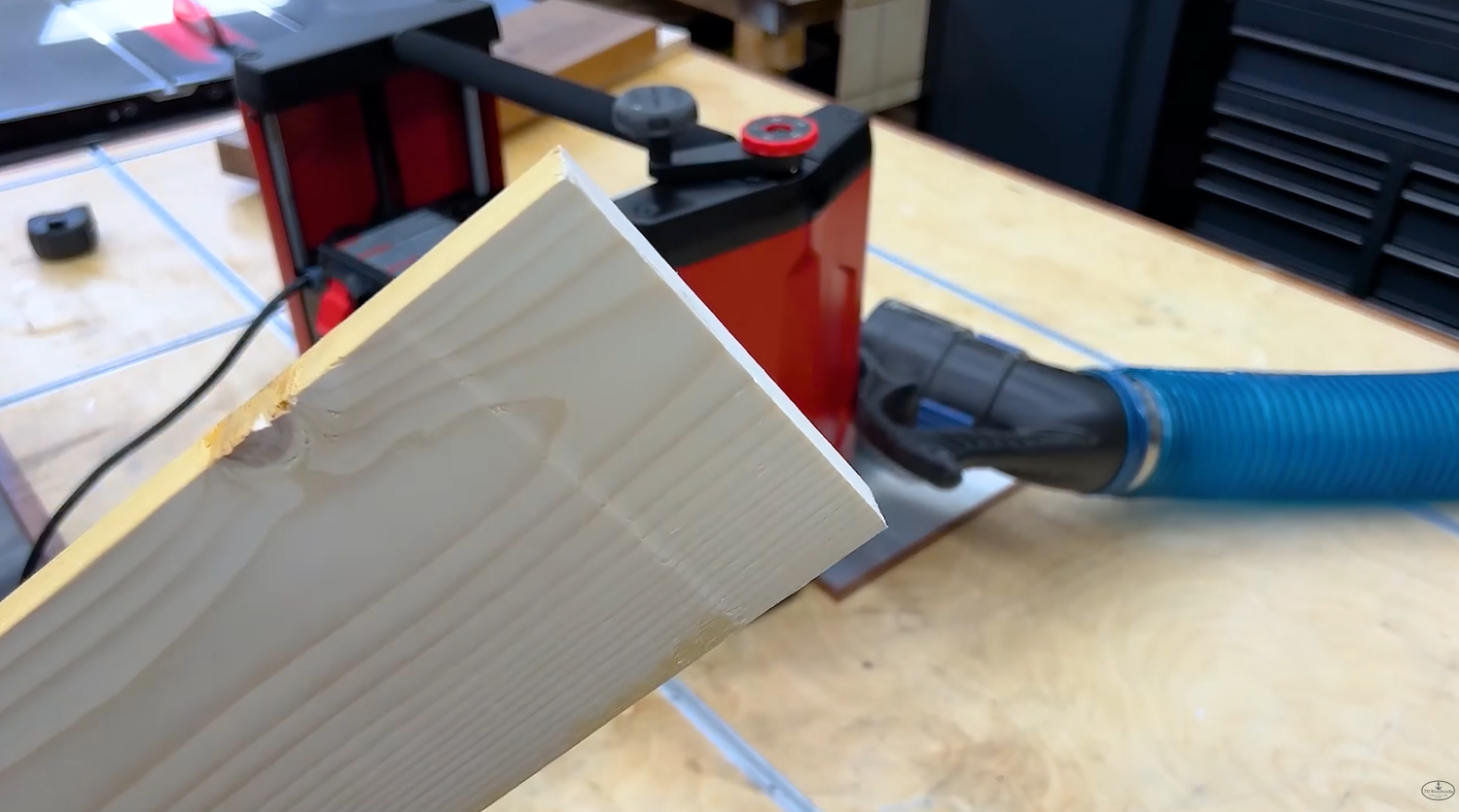 Close up of planer snipe showing a shallow divot cut into the end of a board