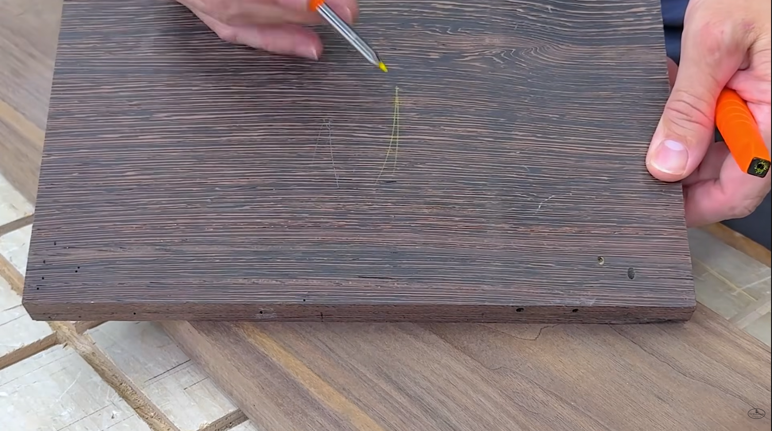 Yellow mark from a Klein Tools mechanical pencil on a dark walnut board