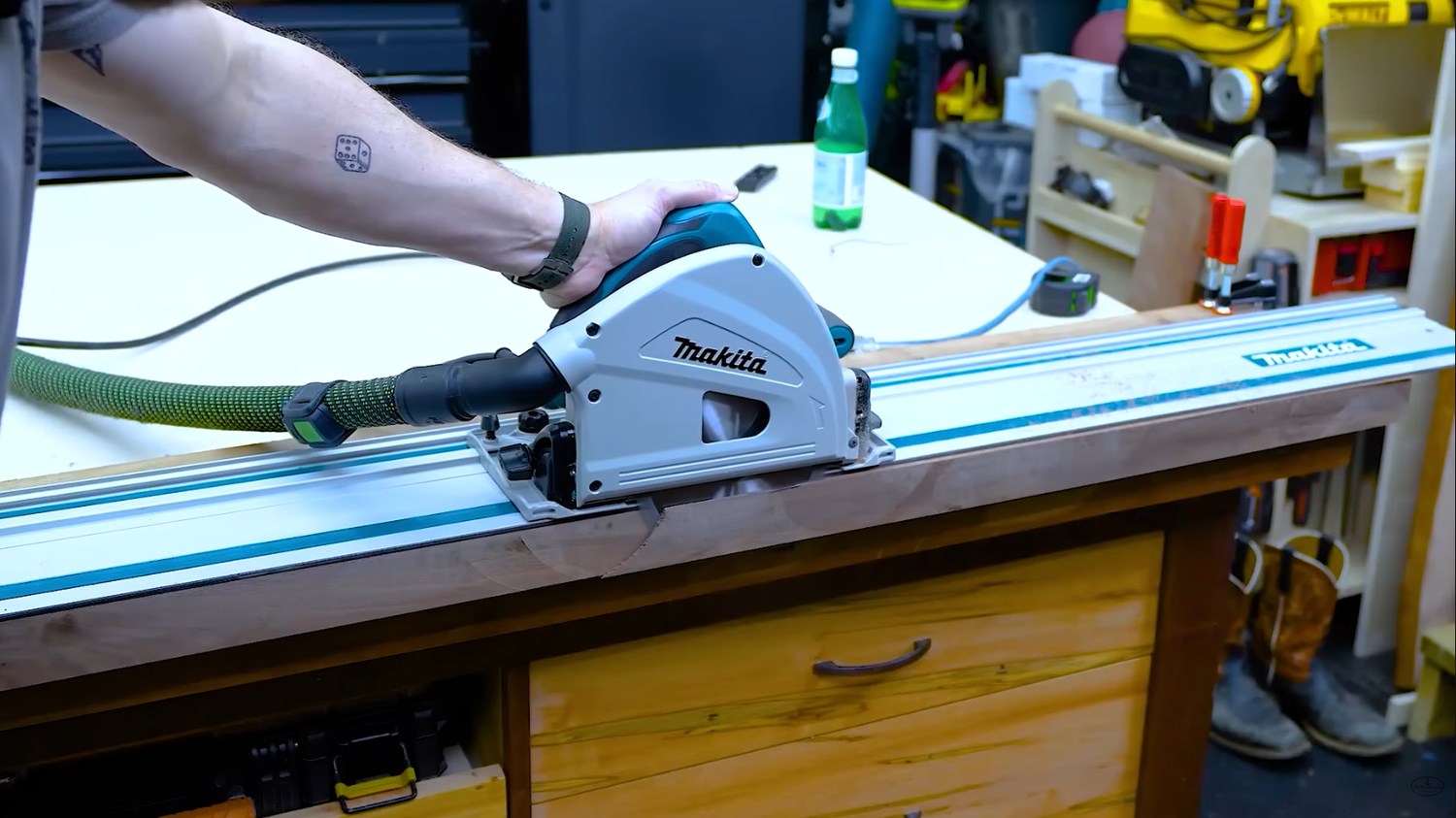Makita SP6000J1 track saw riding on its guide rail during a cut in the 731 Woodworks shop