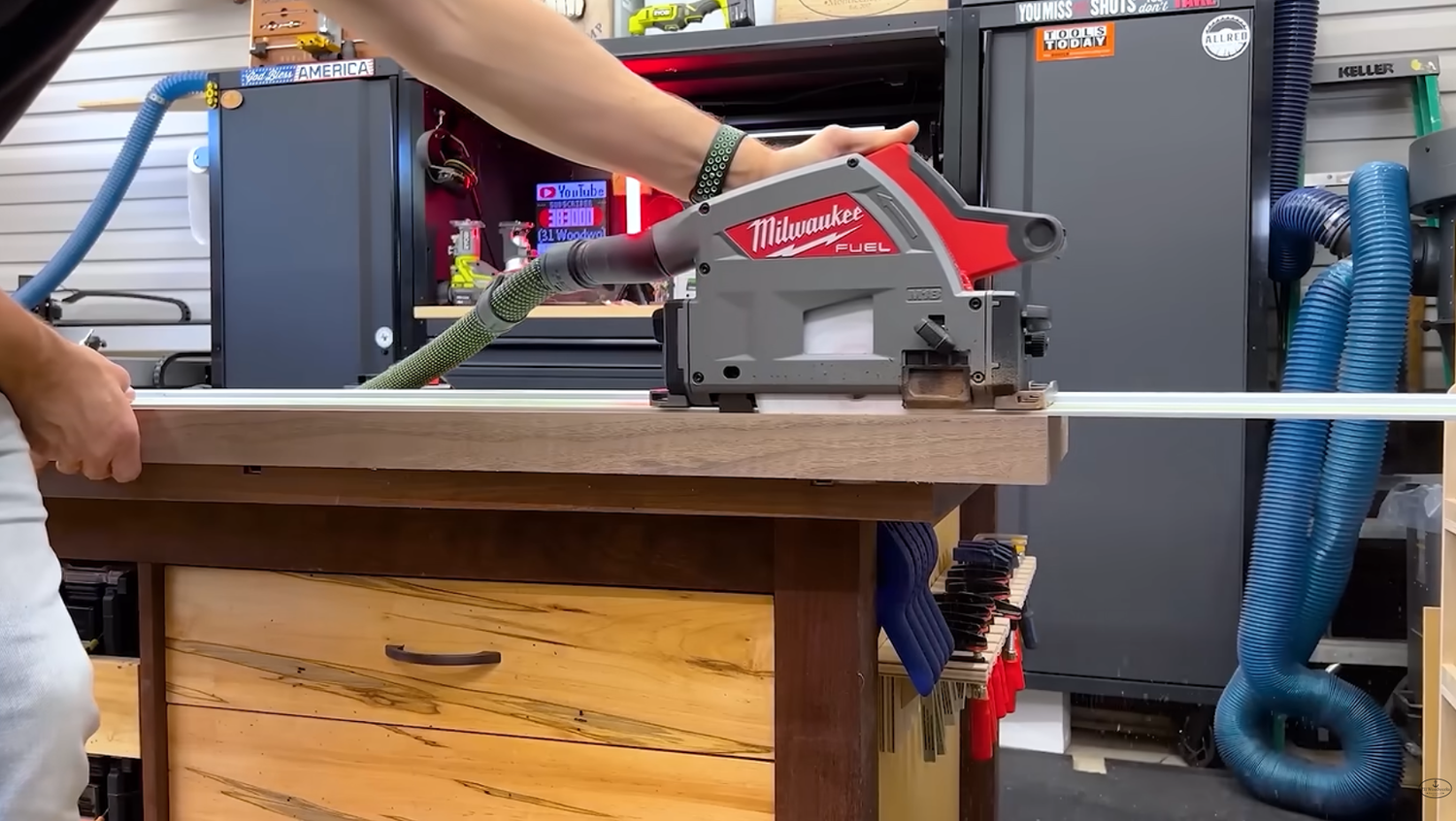 Milwaukee M18 track saw 2831-20 on its track making a plunge cut in the shop