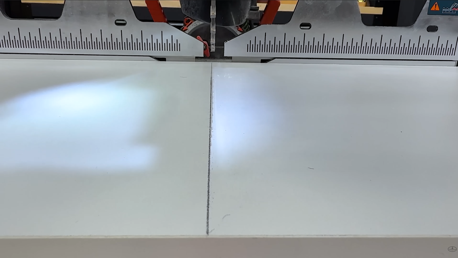 Bosch EXCM341-305GD miter saw shadow line showing a clean cut line on the right side of the blade and a wide shadow on the left