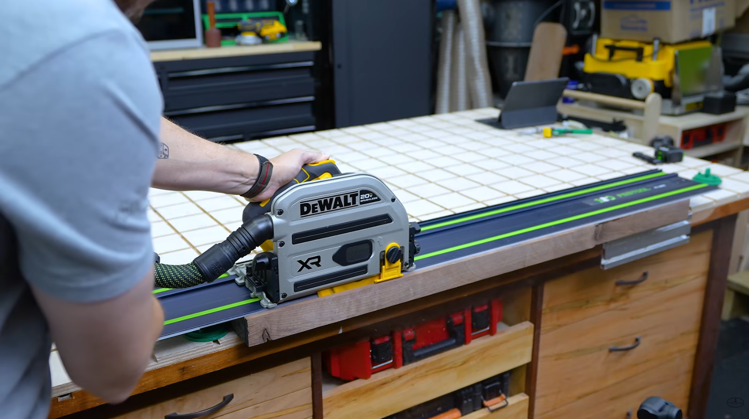 DeWALT XR 20V track saw DCS525B riding on a Festool guide rail using its universal base