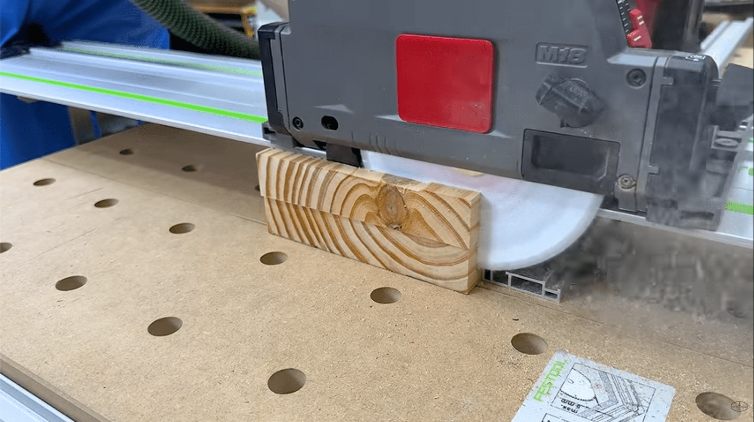 Milwaukee track saw cutting through two stacked 2x8 boards showing the depth of cut limit versus a table saw