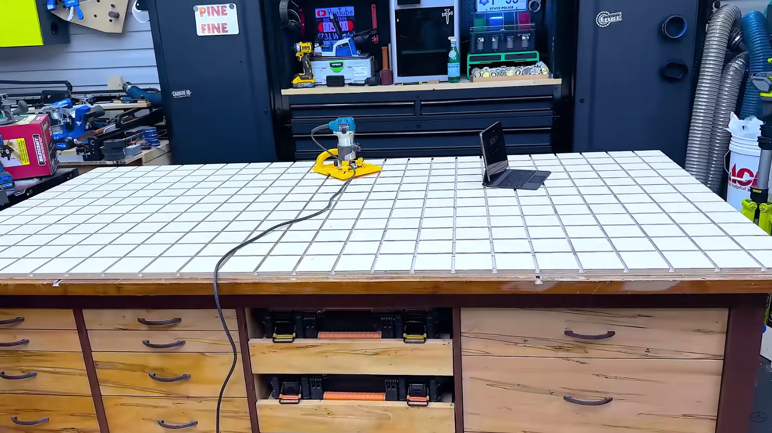 MicroJig grid clamping pattern routed into a plywood workbench top replacing the original T-track