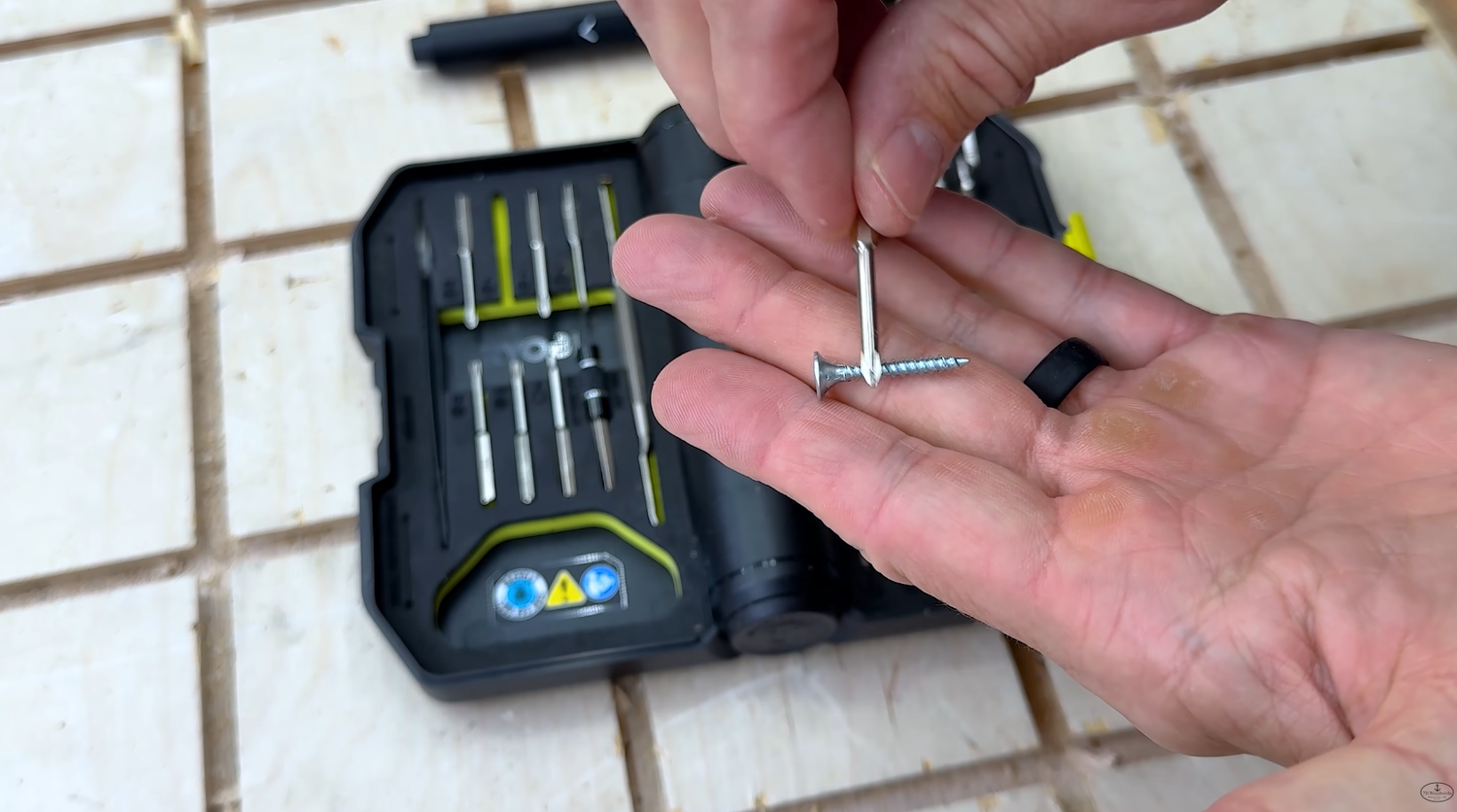 RYOBI Microtechnology Screwdriver Kit Phillips bit holding a small metal screw after being magnetized on the built-in magnet