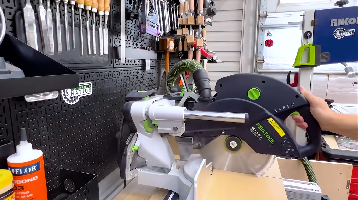 Festool 10-inch miter saw head fully extended showing deflection under side pressure