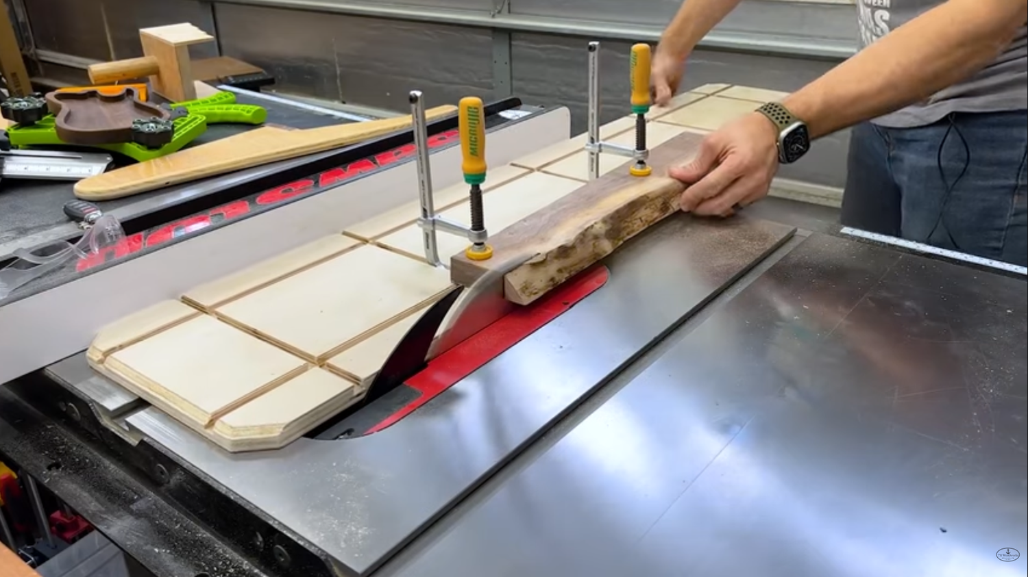 MicroJig dovetail clamps holding a board down on a shop made table saw jointing jig