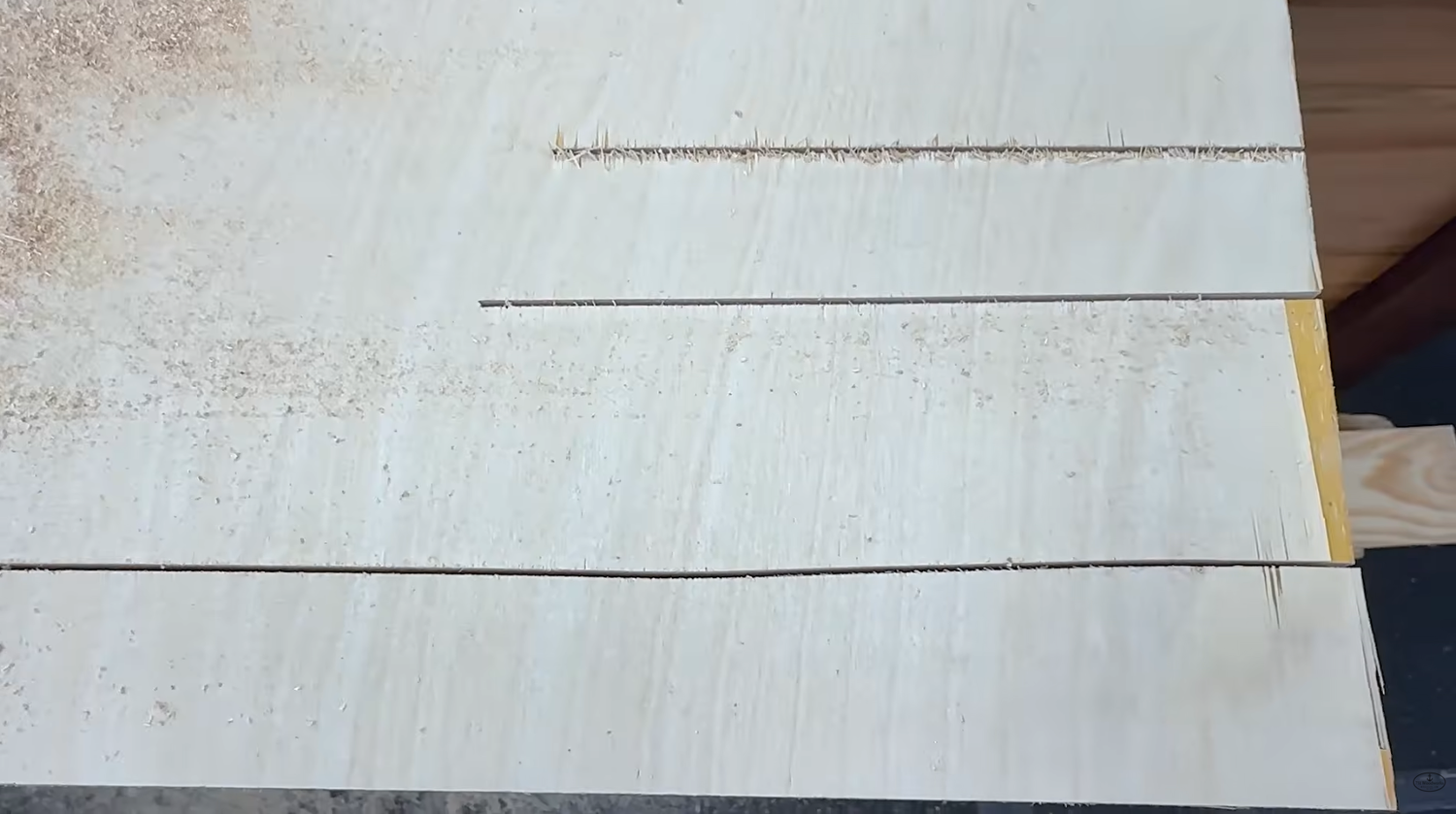Jigsaw cuts in wood compared side by side showing how blade quality affects cut straightness and finish