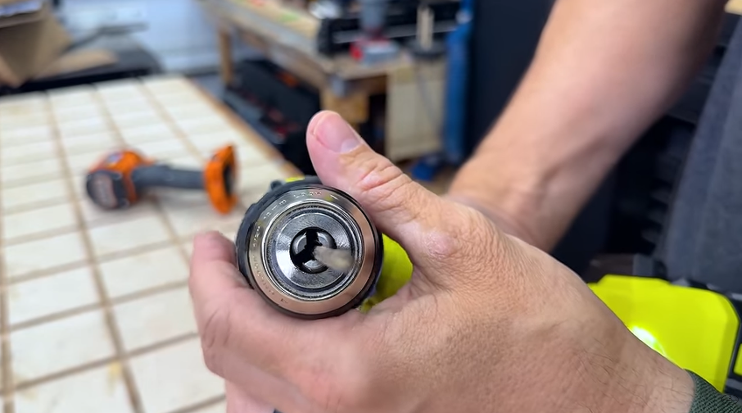 Drill bit seated crooked in a drill chuck showing an off center wobble