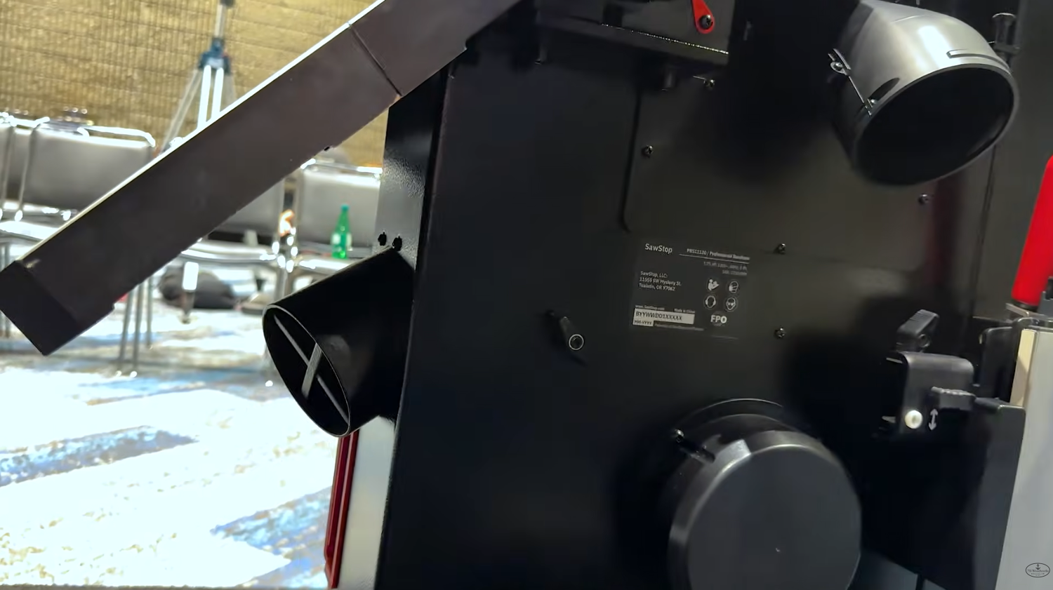 Two 4 inch dust ports and blade shrouding under the tilted cast iron table of the SawStop Professional Bandsaw