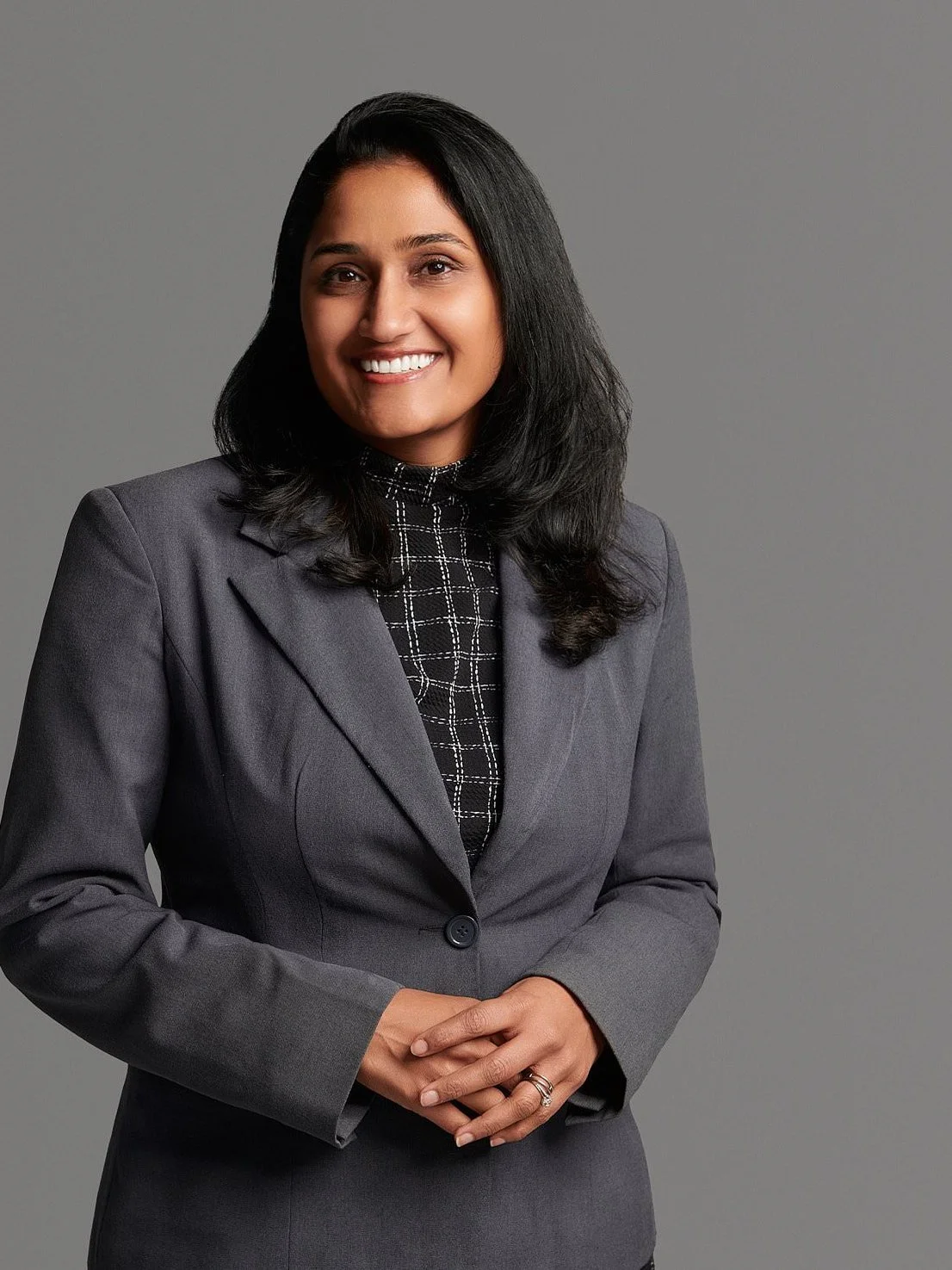 Team headshot, matching gray background