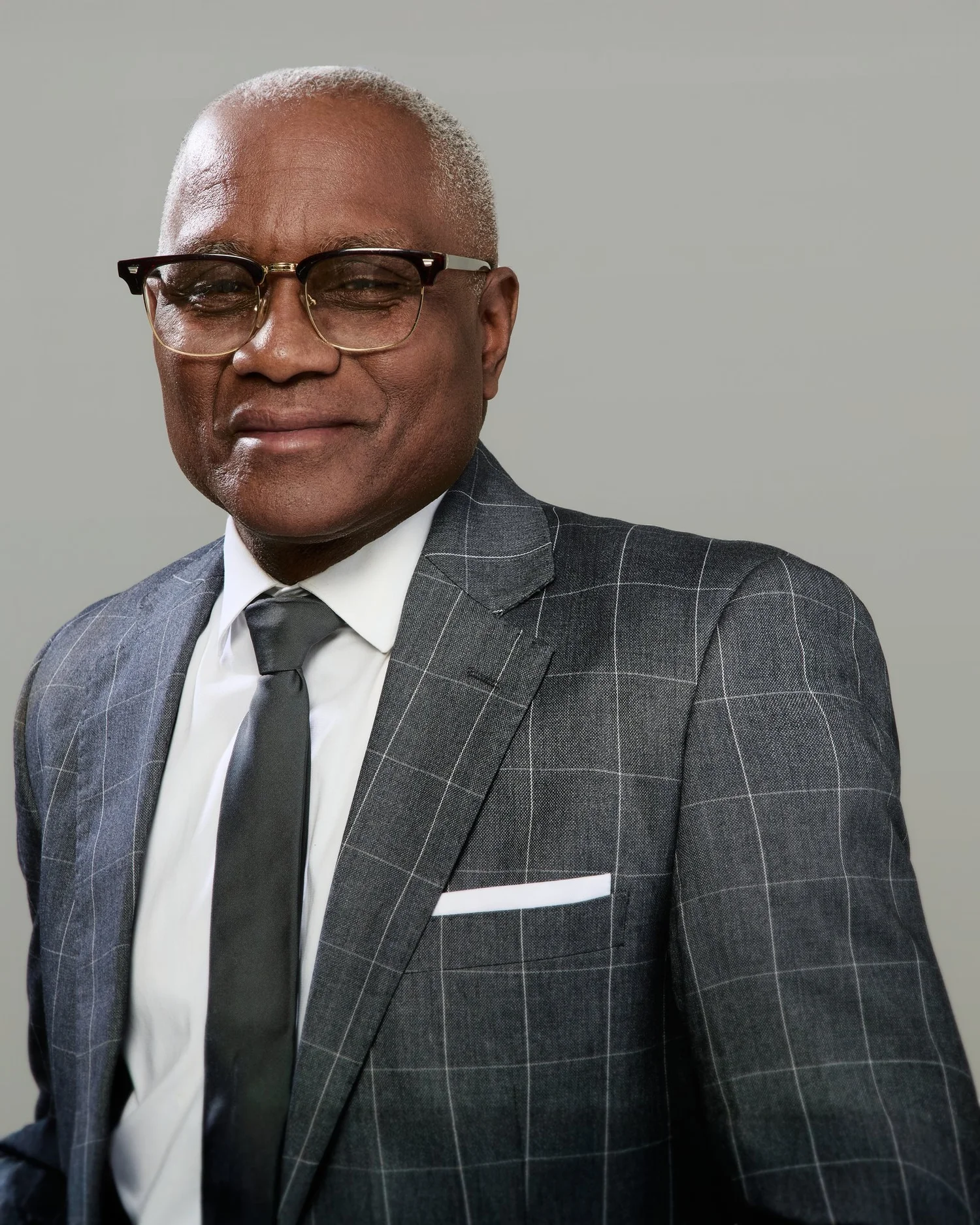 Executive headshot in a gray suit