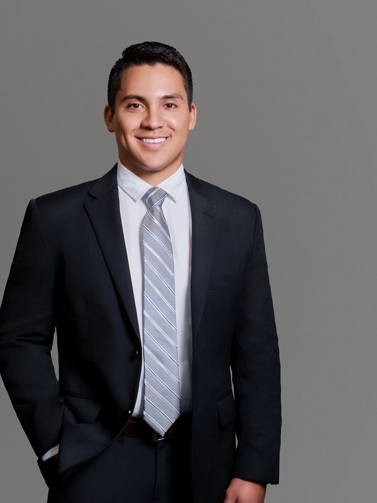 Team headshot, matching gray background