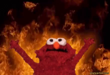 Photo of Elmo from Sesame Street, arms upheld, with fire behind him. He is the patron saint of Chaos Freelancer.