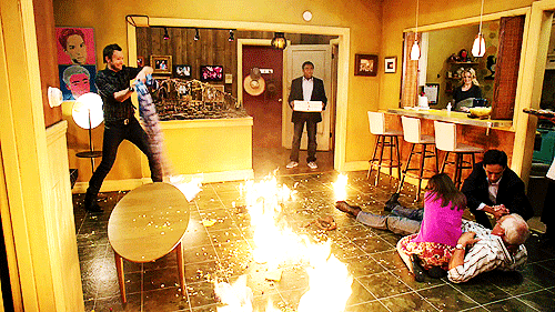 Image of a room, with fire on the floor.This is a scene from community, which I have never seen, so I'll just say imagine chaos and that is this image. 